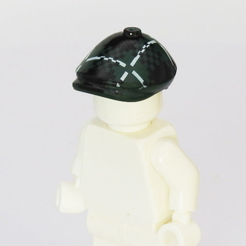White Lego figure wearing a green beret with a white pattern on a light gray background